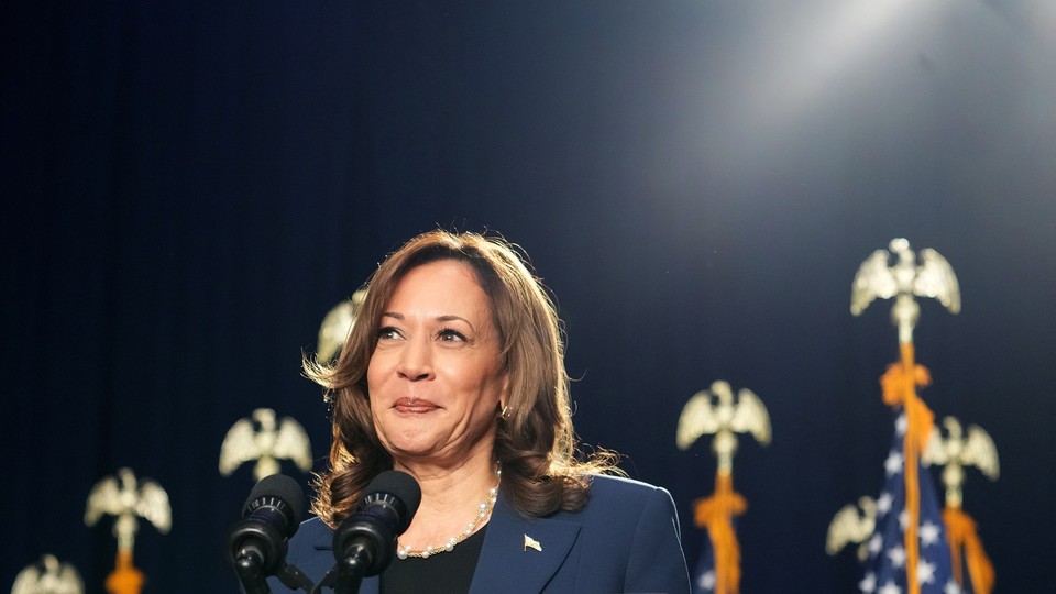 A photo of Kamala Harris standing at a mic