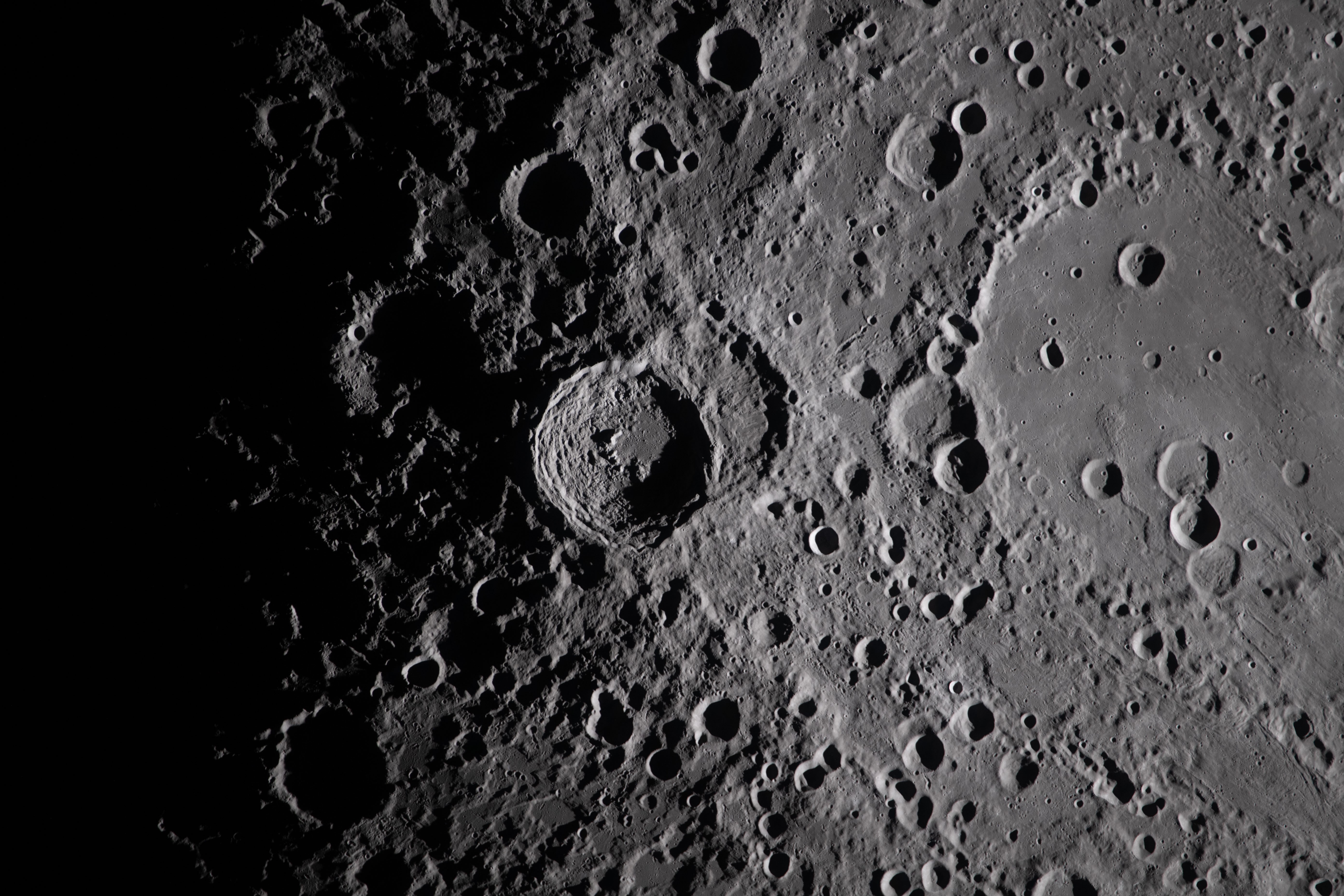 A close view of many rugged craters on the moon's surface.
