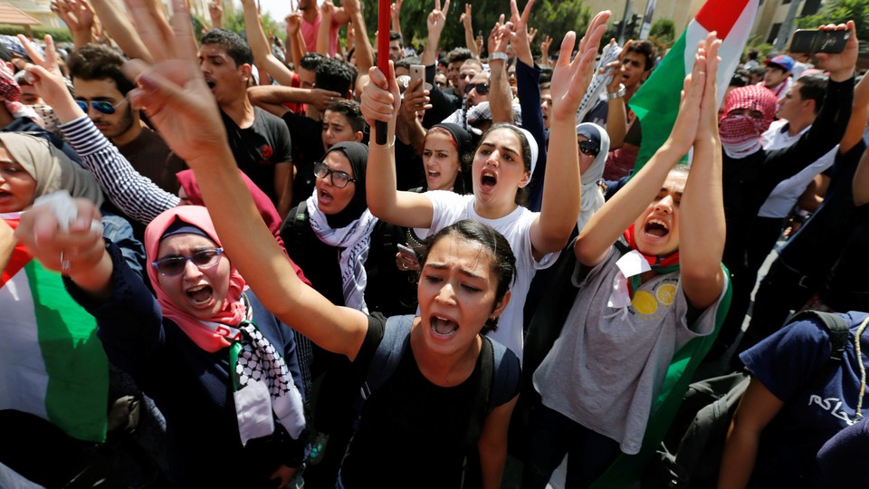 Protestors chanting slogans during a demonstration near the Israeli embassy in Amman.