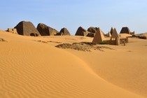 The ruins of several pyramids in the desert sands at Meroë, Sudan