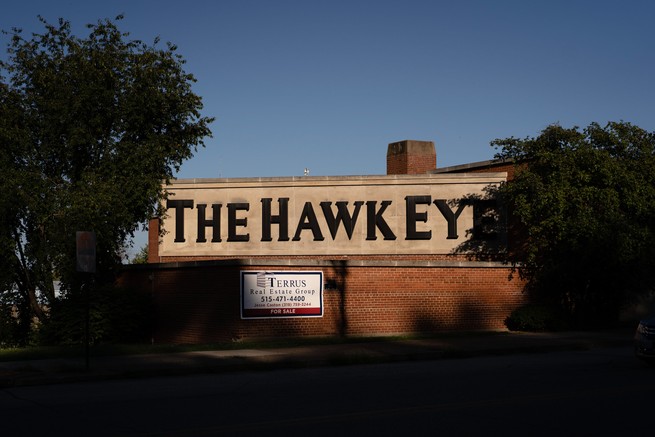 The Hawk Eye building with a For Sale Sign. 