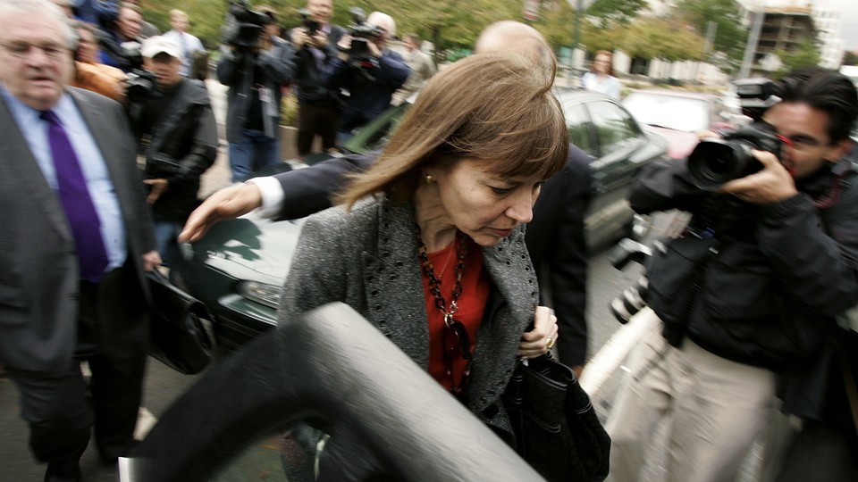New York Times reporter Judith Miller leaves a federal district court, trailed by her attorney, following a 'Plamegate'-related grand jury appearance in 2005.