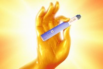 A golden hand in the lotus position holds a GLP-1 drug injector.