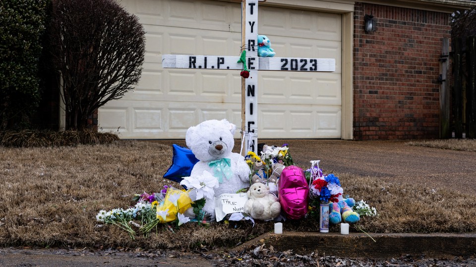 A memorial to Tyre Nichols with stuffed animals, flowers, and a cross