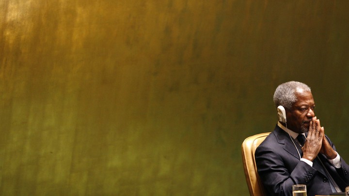 Annan sits with headphones as he listens to George W. Bush at the UN General Assembly in 2006.