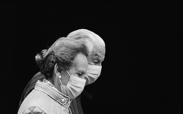 Two older adults wearing masks