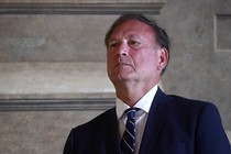 Photograph of Samuel Alito wearing a suit and tie from a low vantage point