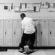 A student goes through his locker in a hallway