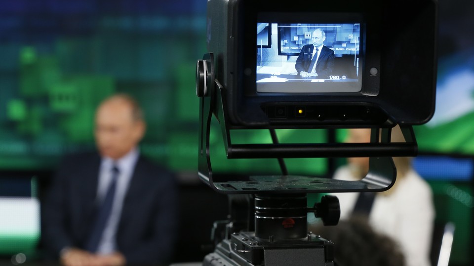 Russian President Vladimir Putin is interviewed at the headquarters of RT in Moscow.