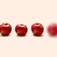 Five apples in a line, but the furthest one on the right is blurry