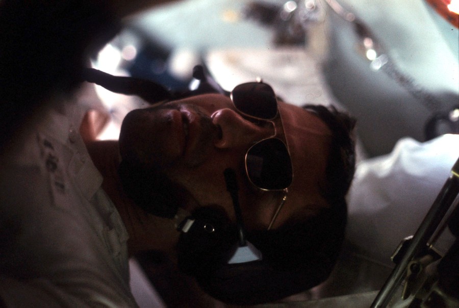 A close view of a man wearing sunglasses, captured sideways