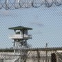 A jail watchtower seen through a fence