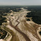 photo with aerial view of dried riverbed stretching into the distance, marked with dozens of smaller channels