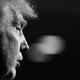 Black-and-white photograph of Donald Trump in profile from the right, with the background out of focus
