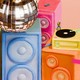 Colorful speakers, a turntable, a disco ball, and tiny people dancing