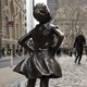 The "Fearless Girl" statue faces down Wall Street's famous Charging Bull.