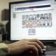 An officer looks through photos in a federal facial-recognition system
