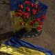 This photograph taken on March 31, 2024, shows a Ukrainian flag on a grave of a victim of the Russian strike that hit a cafe last year, at a cemetery in the village of Groza, Kharkiv region, amid the Russian invasion of Ukraine.