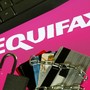 A keyboard, credit cards, chain, and padlock next to the Equifax logo