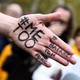 A picture shows the messages '#Me too' and #Balancetonporc ('expose your pig') on the hand of a protester. 