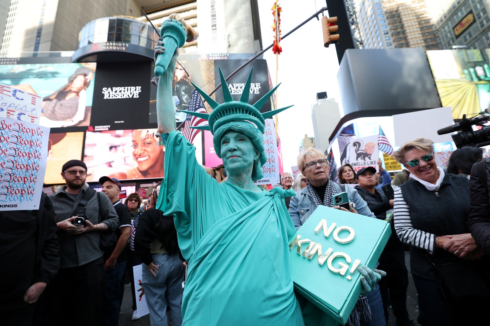 A person dressed in a Statue of Liberty costume participates in a