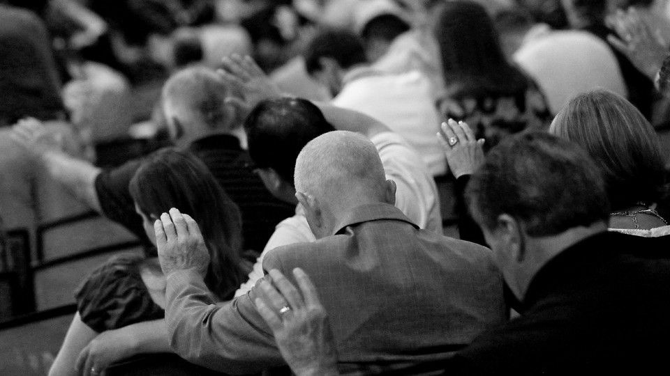 Group of people praying at the Southern Baptist Convention.