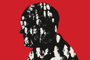 Louis C.K. in profile against a red backdrop