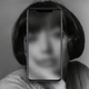 A black-and-white portrait of a woman with a phone over her face