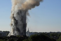 Smoke billows as firefighters deal with a serious fire in a tower block at Latimer Road in West London on June 14, 2017. 