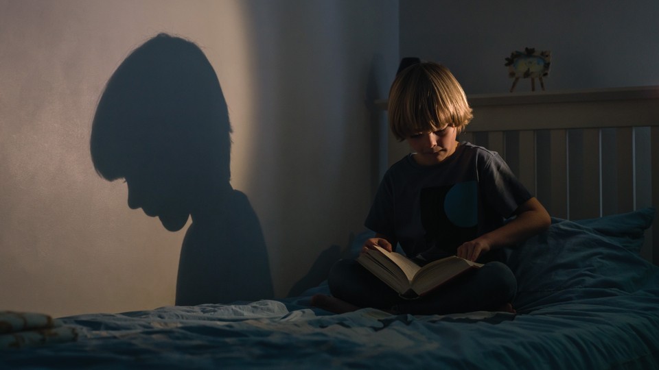 child reading a book alone in their bedroom