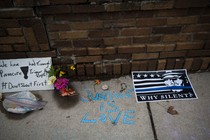 Memorial flowers and posters protesting the shooting of Justine Damond by police