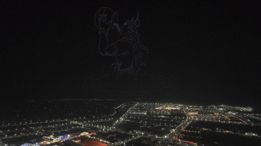 A drone light show, depicting an image of the Hindu Lord Shiva, high above an encampment