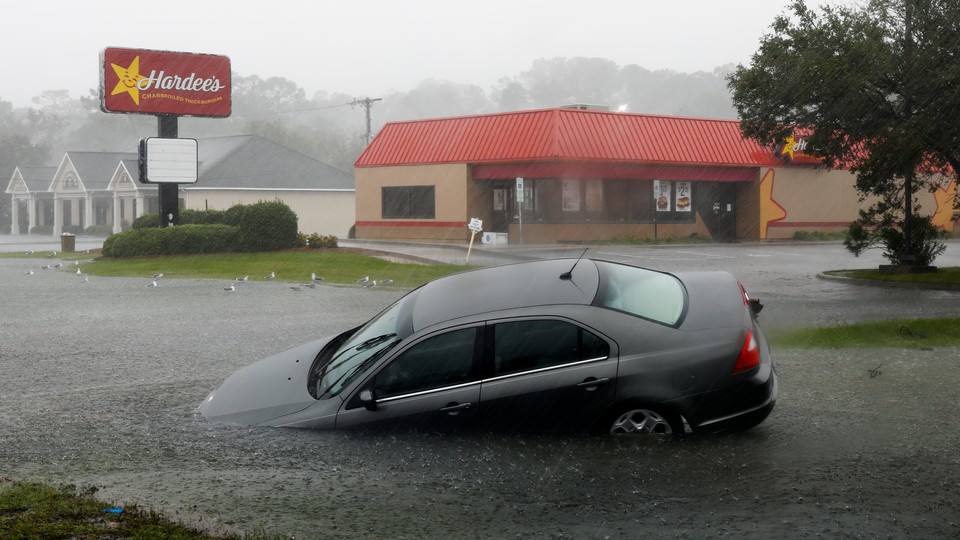 A car washed away by flood waters remains partially submerged in the torrential rains that followed Hurricane Florence.