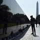 A photograph of a silhouette of a person observing the Vietnam Veteran's Memorial in Washington, D.C.