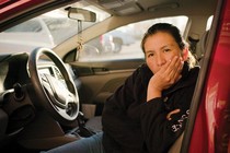 Alma Alvarez sitting in the front seat of her car