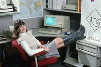 An Apple employee poses with a personal computer in 1986.