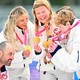 Members of Team USA celebrate on the podium with their gold medals.