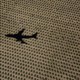 A shadow of a plane flying over rural land