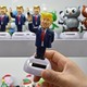 Hand holding a Donald Trump toy