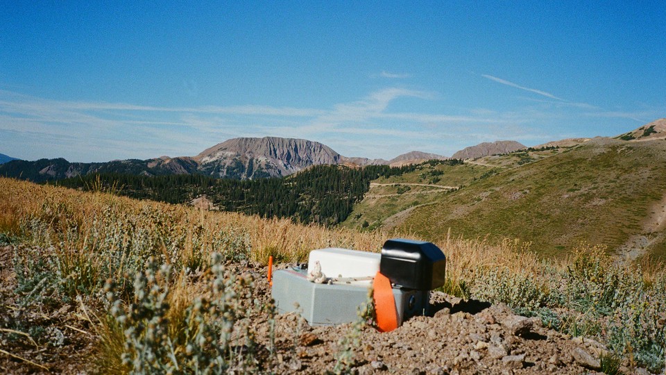 A mountain range with a small hexagonal silver node in the foreground
