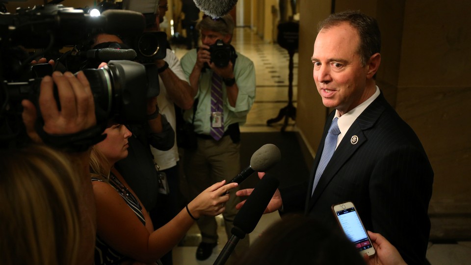 Adam Schiff stands with reporters.