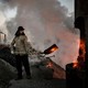 A Chinese labourer loads coal into a furnace as smoke and steam rise from an unauthorized steel factory on November 3, 2016, in Inner Mongolia, China.