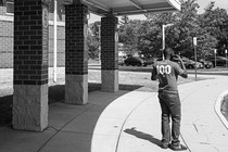 A Haitian father on the phone outside an elementary school