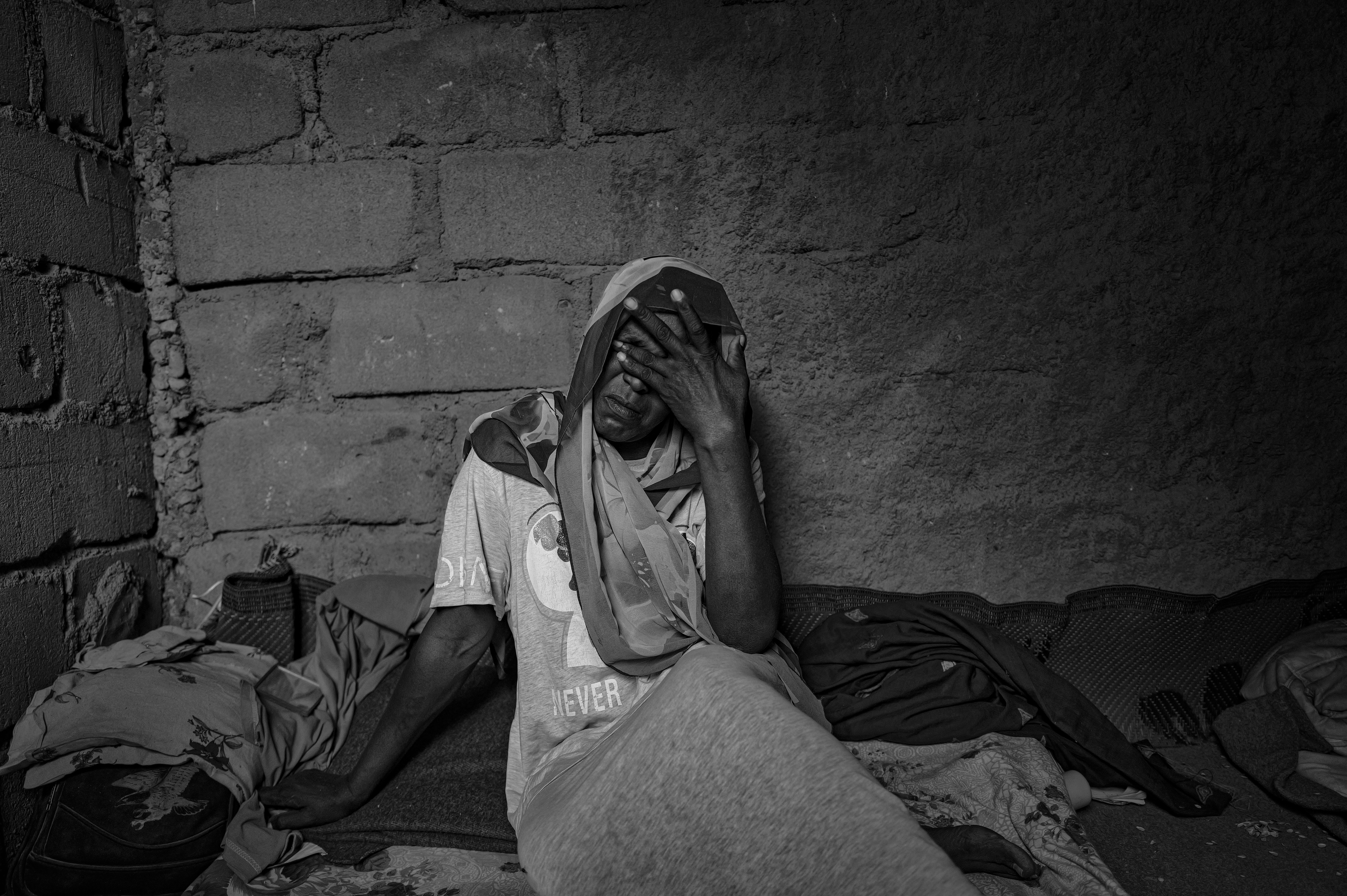 Picture of Fatima Suleiman weeping as she recounts her journey from El-Fasher in North Darfur; to Zamzam; to Tawila, Sudan; to Tiné; and then to the Iridimi camp. 