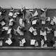 Rows of handguns hanging on a peg board