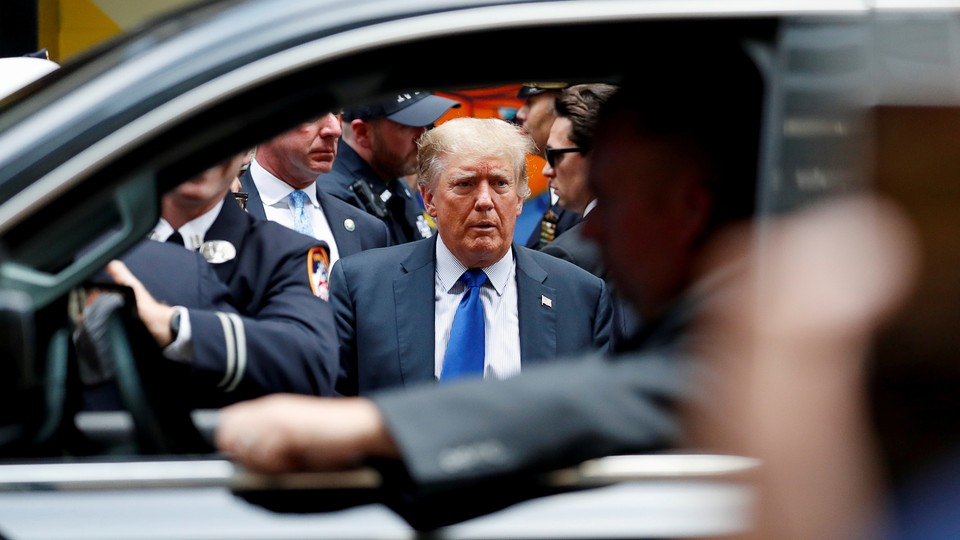Donald Trump framed by a car window