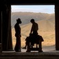 A silhouette of two men in a barn