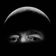 A photograph of Jeff Bezos that has been edited to portray the billionaire's head as the surface of the moon