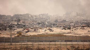 A view of smoking ruins in Gaza from the southern Israeli border