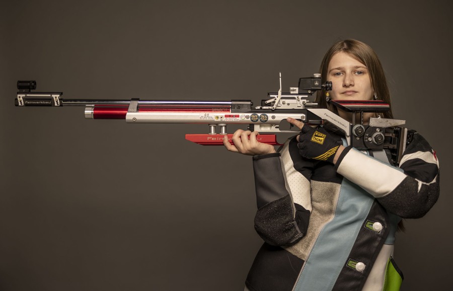 An Olympic shooter poses with her rifle.